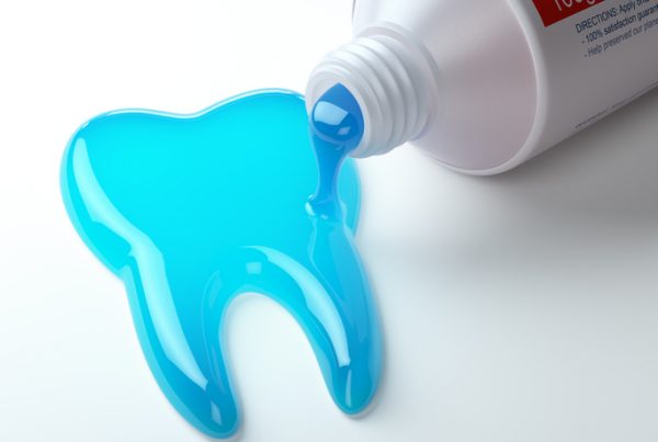 Toothpaste in the shape of tooth coming out from toothpaste tube. Brushing teeth dental concept.