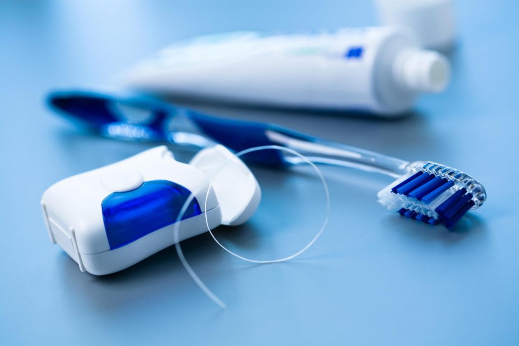 dental floss and toothbrush