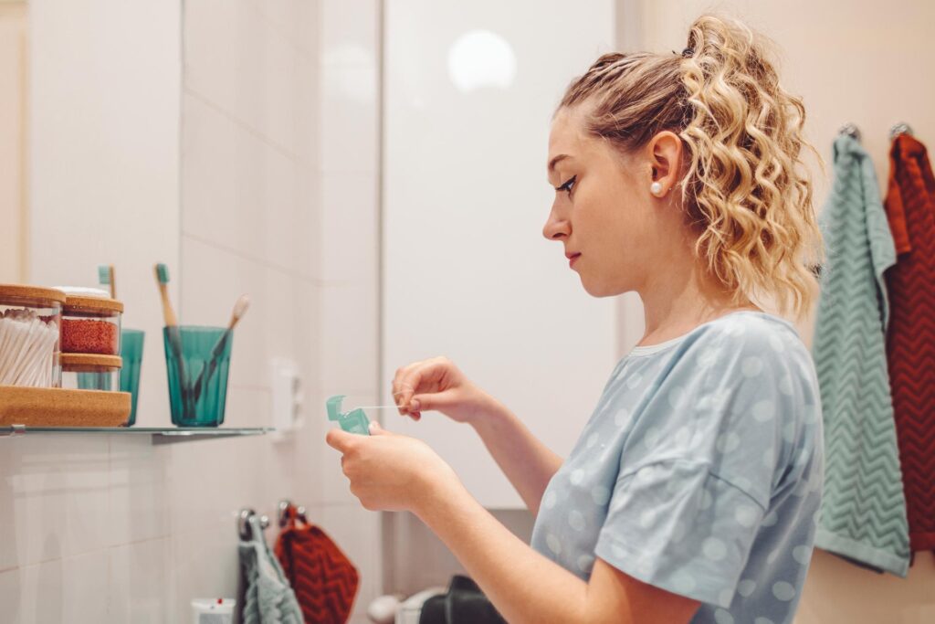 Woman flossing teeth